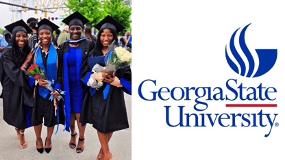 Four women in graduation robes next to the Georgia State University logo