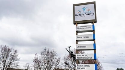 A tall sign displaying the DeKalb County School District logo