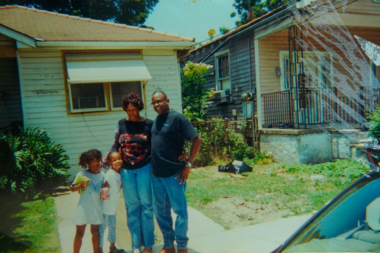 A picture of a man woman and two little girls.