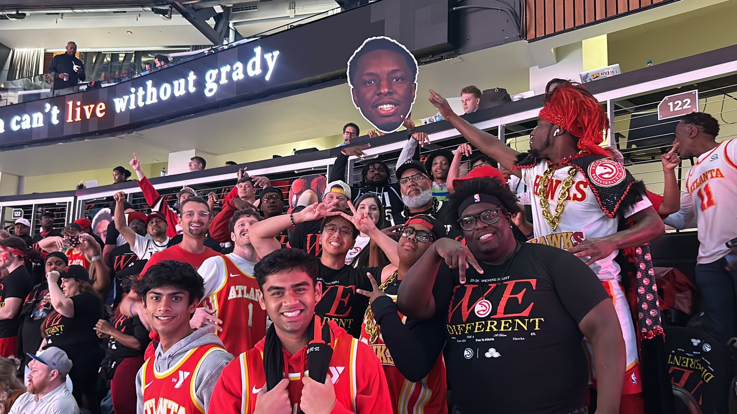 A group of fans cheering and smiling.