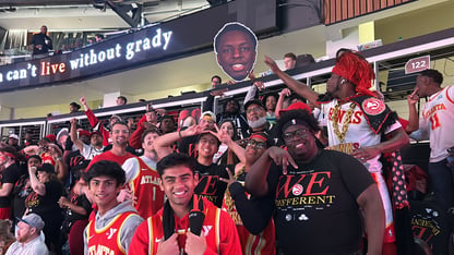 A group of fans cheering and smiling.