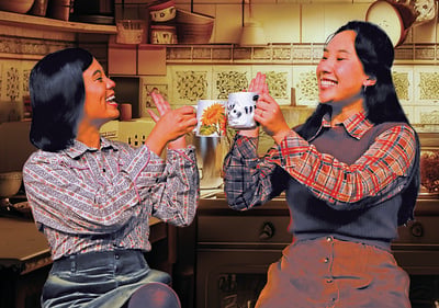 Two women laughing & having tea