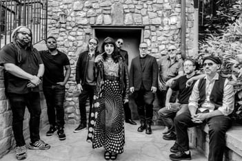 The band Ruby Velle & The Soulphonics pose together outdoors in Atlanta
