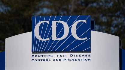 The blue and white sign of the Centers for Disease Control and Prevention building in Atlanta
