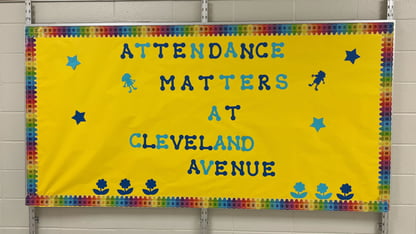 A yellow bulletin board that says Attendance Matters at Cleveland Avenue in blue letters.