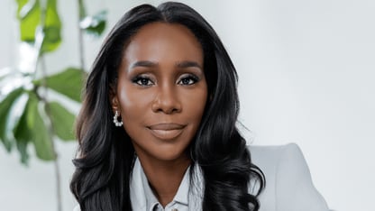 Portrait of journalist Abby Phillip wearing a light gray suit