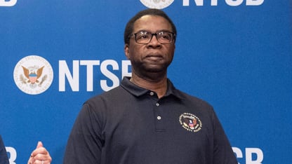 Alvin Brown stands in front of a blue NTSB background at a press conference