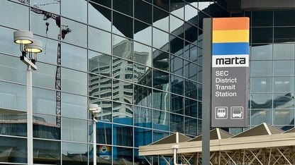 A MARTA sign in front of a glass building