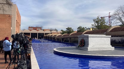 A long blue pool. In the middle of the pool is the stone tomb of Martin Luther King Jr. and Coretta Scott King.