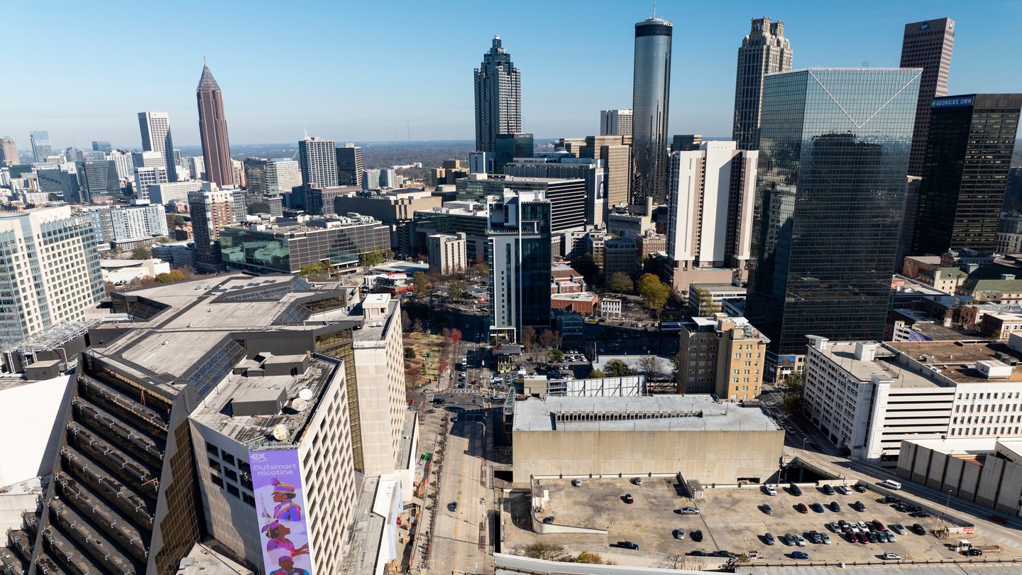 Several building in downtown Atlanta are shown on a sunny day with blue skies