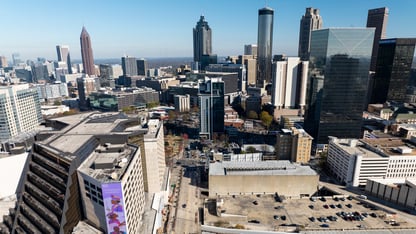 Several building in downtown Atlanta are shown on a sunny day with blue skies