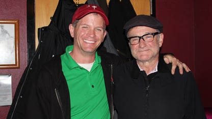 Marshall Chiles places an arm around Robin Williams for a photo