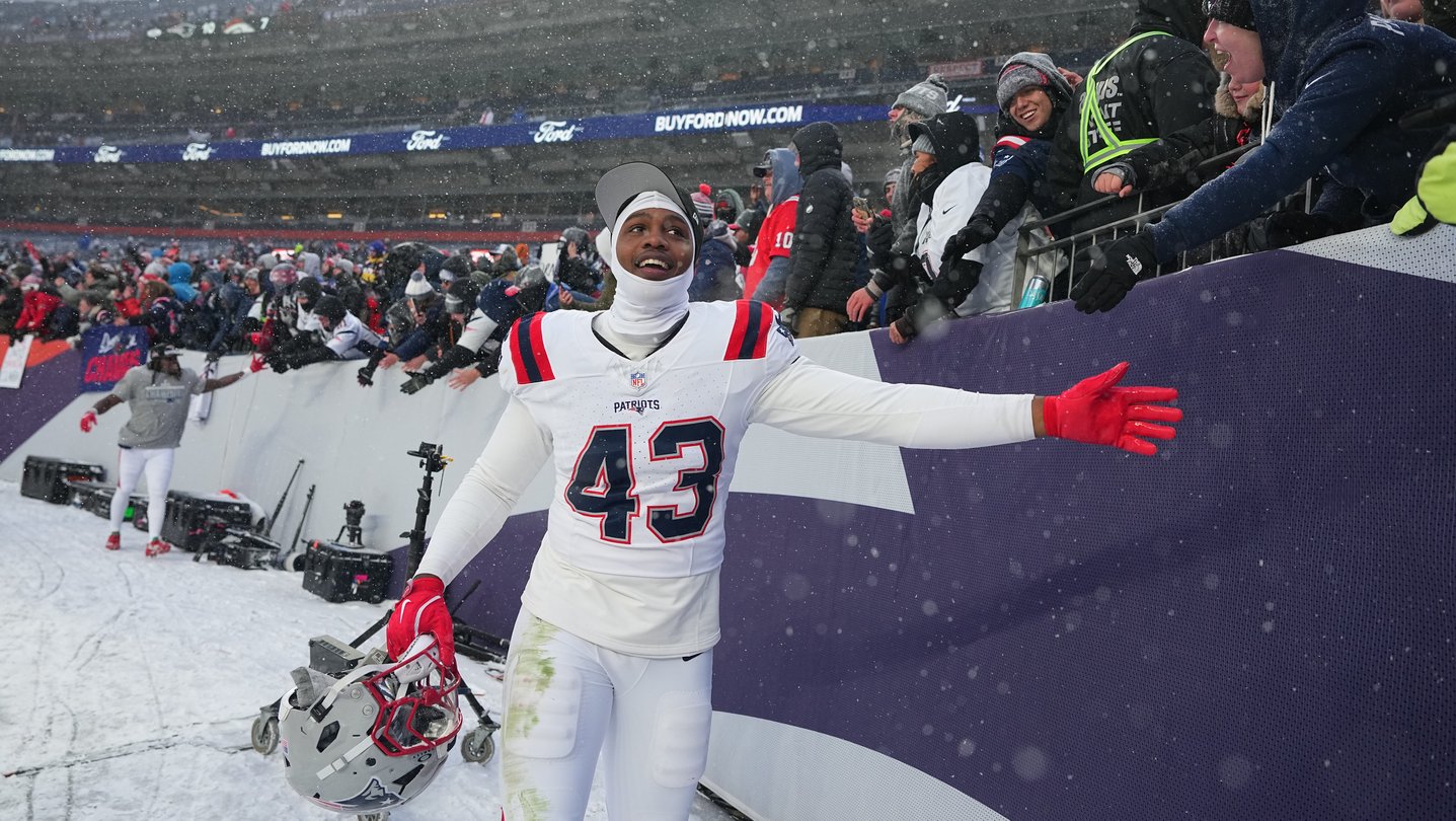 Bradyn Swinson stands near spectators at a football game