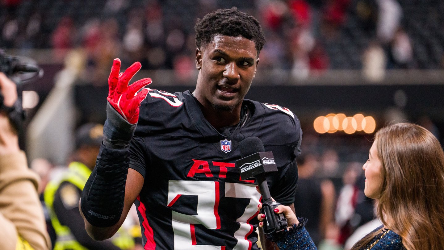 Falcons player James Pearce talks to a reporter after a football game