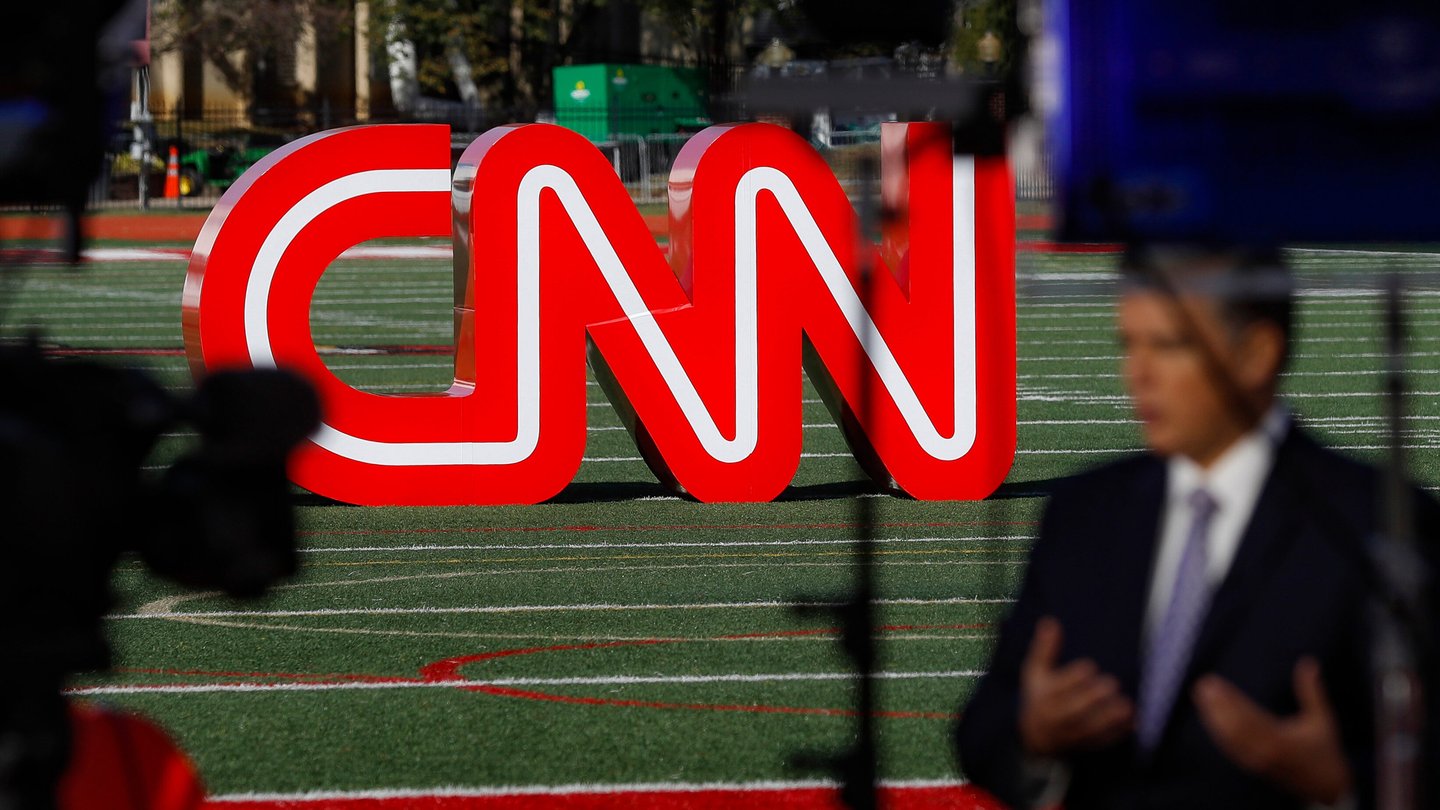 A red CNN sign on an athletic field