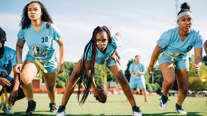 Several girls begin running on a field