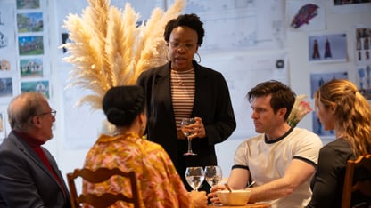 The cast of ‘Fires, Ohio’ gathered around a table during rehearsals at the Alliance Theatre, design references covering the wall behind them