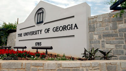 A white sign for the University of Georgia