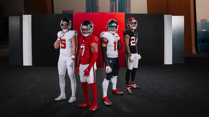 Four Atlanta Falcons players in uniforms.