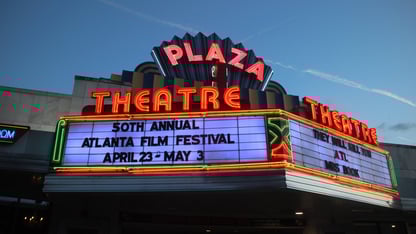 The outside of the Plaza Theatre at night.