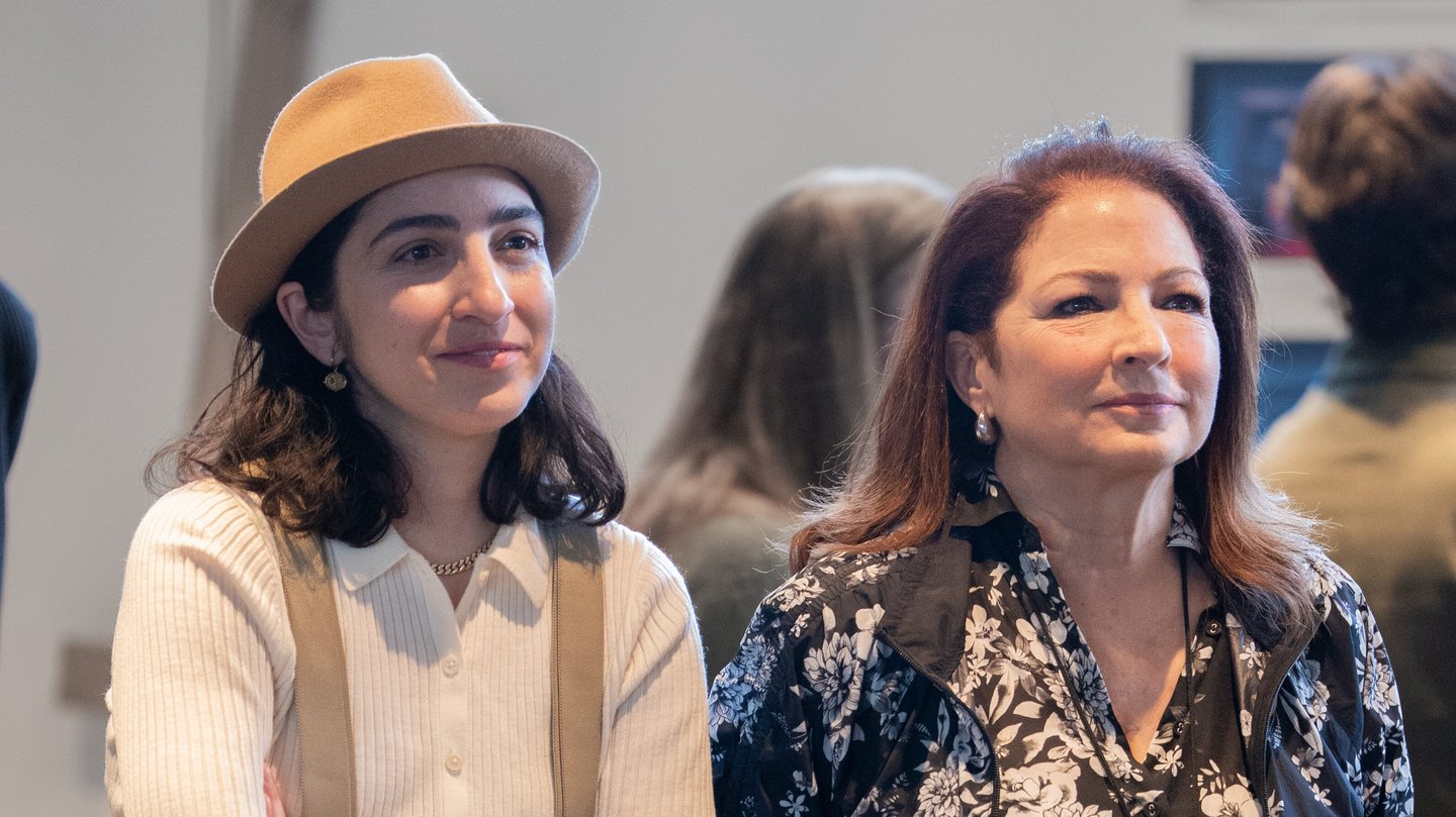 Emily Estefan wearing a hat and Gloria Estefan stand together watching a Basura rehearsal at Alliance Theatre in Atlanta.