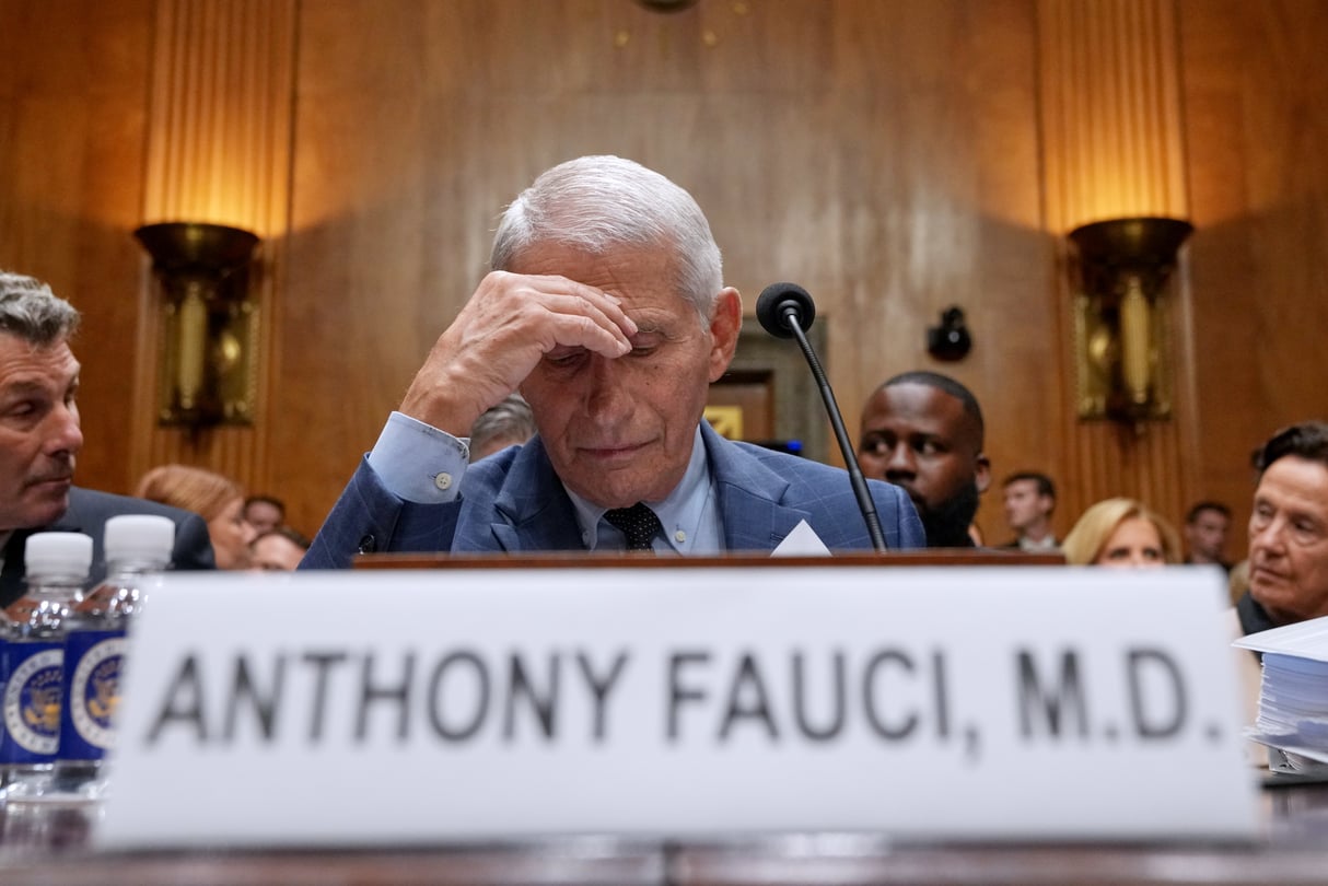 Dr. Anthony Fauci sits in court with his head down.