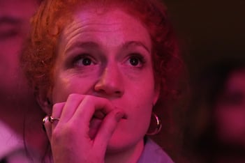 A woman looks up pensively