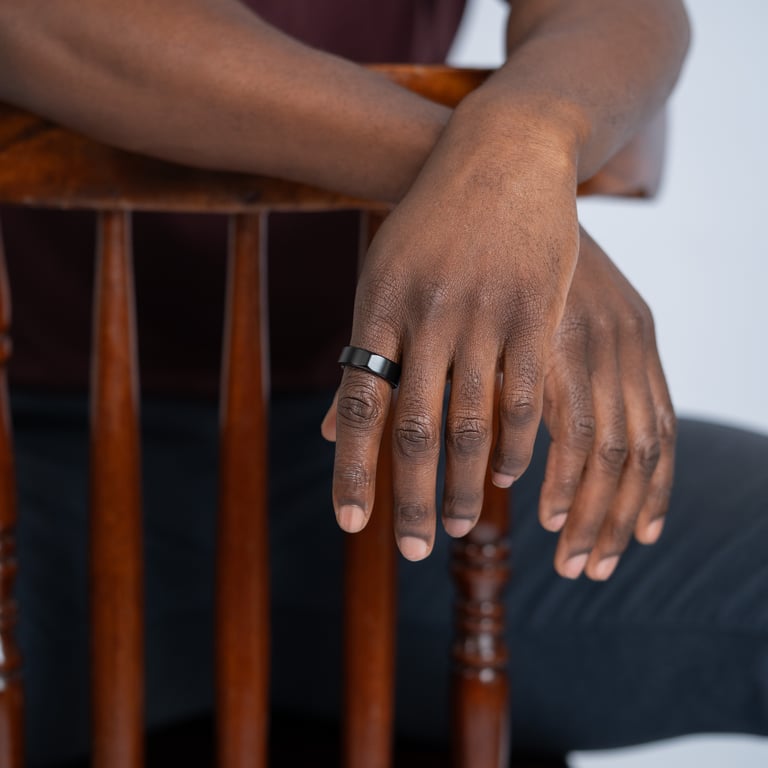Ring One Phantom Black — hand on chair