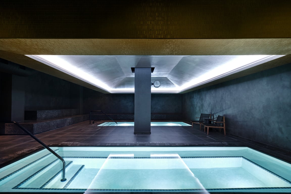 This New York City Spa Draws Inspiration From The Hero's Journey | Bathhouse Flatiron lobby entrance | Bathhouse Flatiron second sauna | Bathhouse Flatiron pools | Bathhouse Flatiron concrete bath | Bathhouse Flatiron dry sauna | Bathhouse Flatiron walkway and lockers | Bathhouse Flatiron treatment walkway | Bathhouse Flatiron infrared sauna