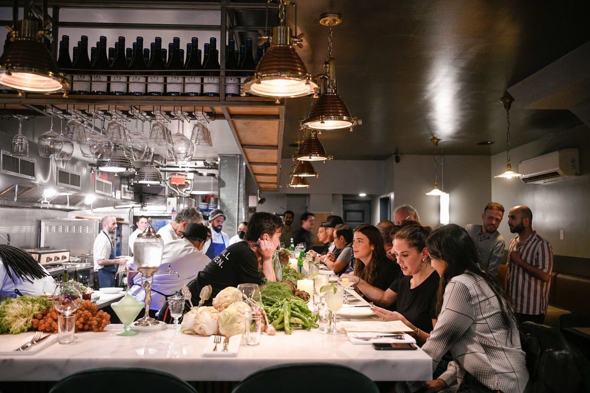 Indulge in Contemporary Israeli Cuisine at This Buzzy Manhattan Restaurant | Shmone restaurant plate | Shmone restaurant plate spread | Shmone restaurant interior seating | Shmone restaurant interior green seating