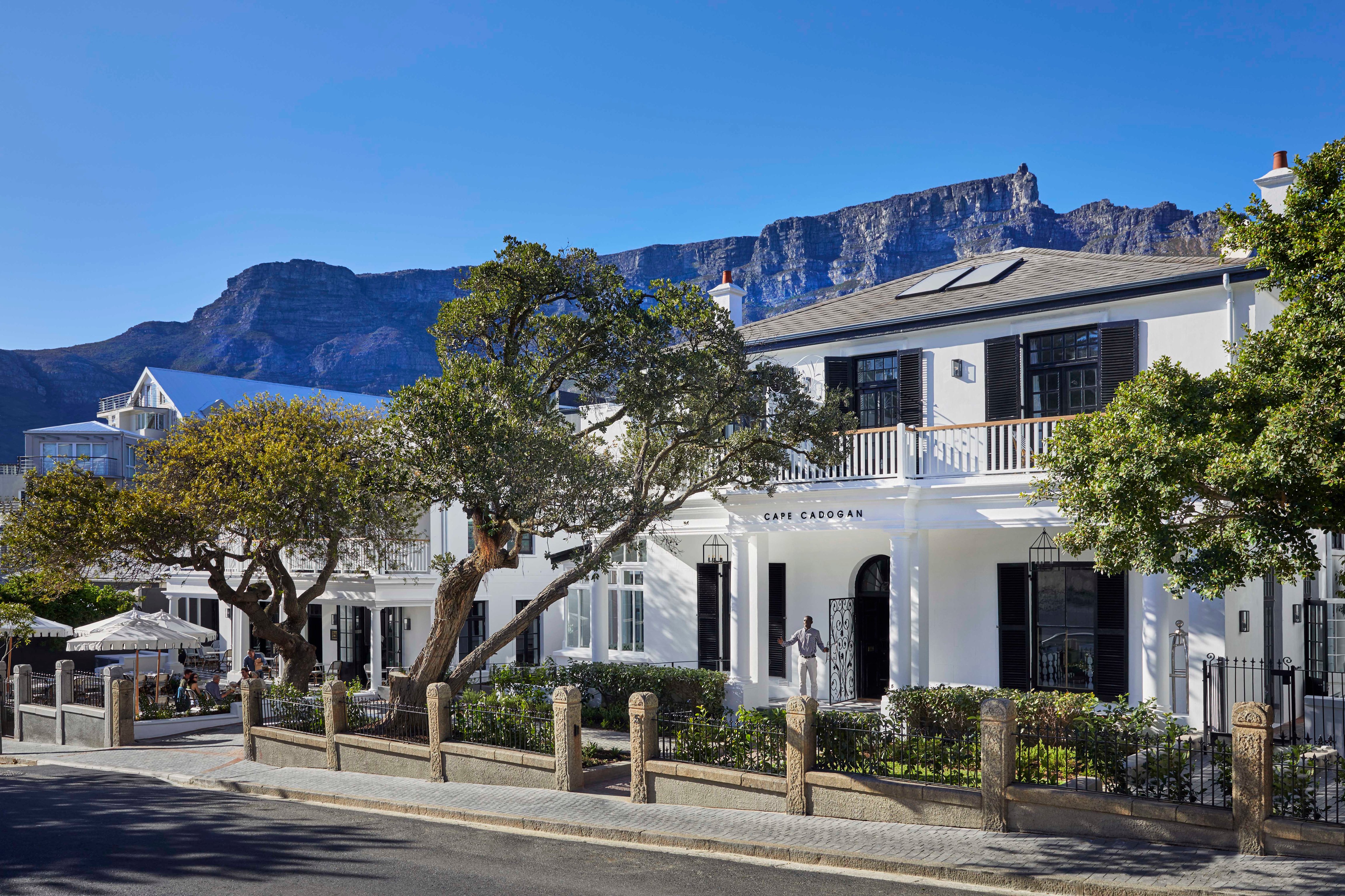 Cape Cadogan white heritage facade with Table Mountain backdrop, Gardens, Cape Town.