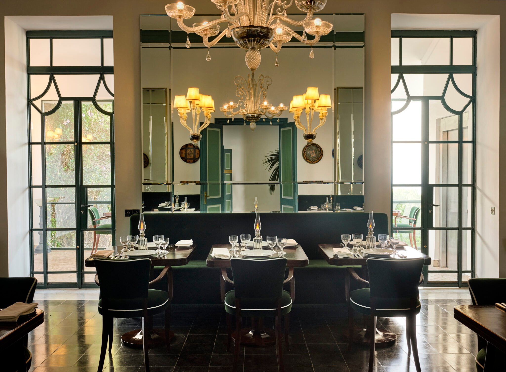 This 12-Room Hotel in Morocco Was Once Yves Saint Laurent’s Secluded Sanctuary | Yves Saint Laurent’s Villa Mabrouka vintage window | Yves Saint Laurent’s Villa Mabrouka garden | Yves Saint Laurent’s Villa Mabrouka outdoor pool | Yves Saint Laurent’s Villa Mabrouka outdoor seating | Yves Saint Laurent’s Villa Mabrouka dinner spread