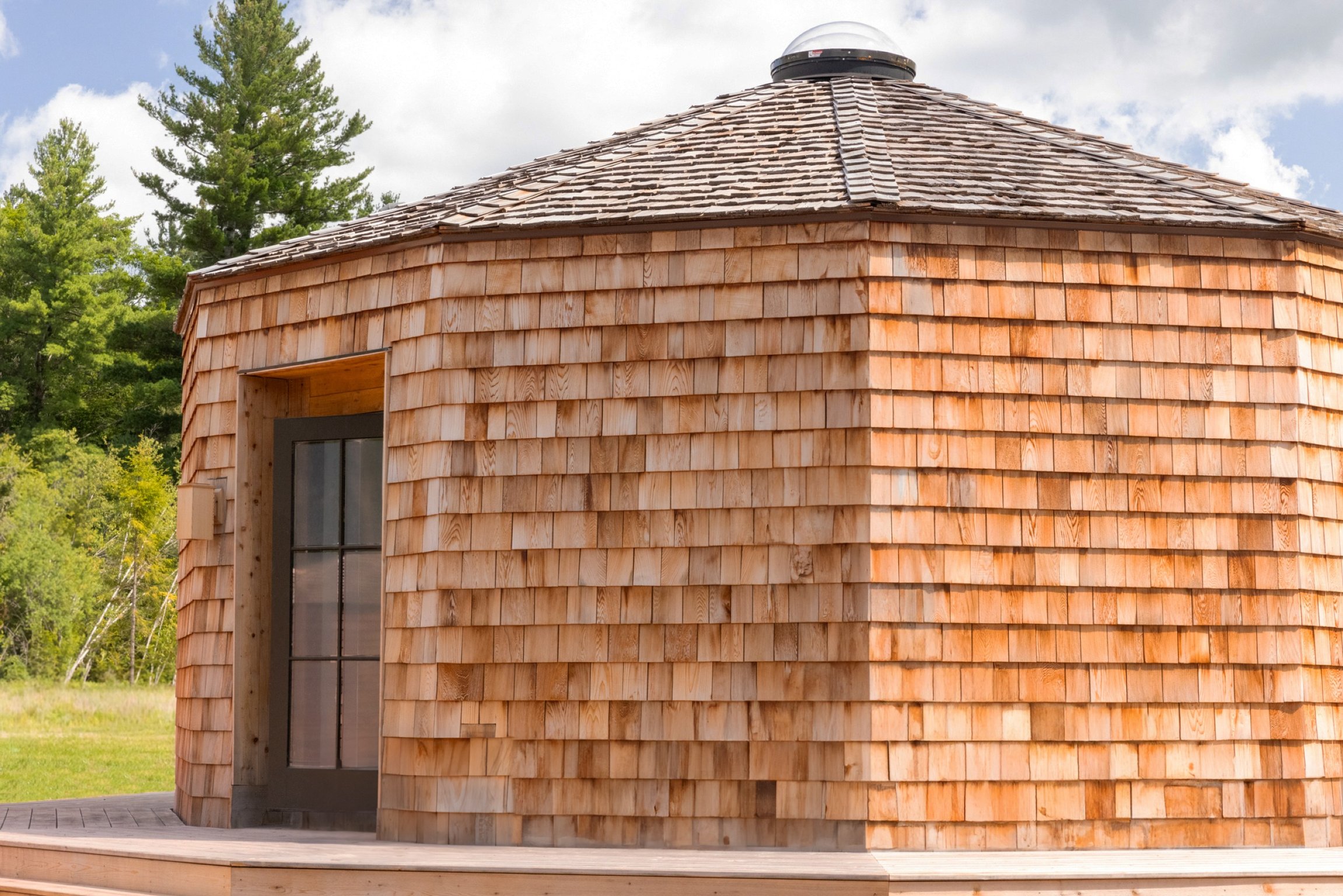 This Beloved Catskills Hotel Now Offers Coveted Cabins | The Rounds at Scribner's Apex Lounge | The Rounds at Scribner's communal seating | The Rounds at Scribner's bathroom | The Rounds at Scribner's Apex lounge lighting | The Rounds at Scribner's bar seating | The Rounds at Scribner's bedroom linens