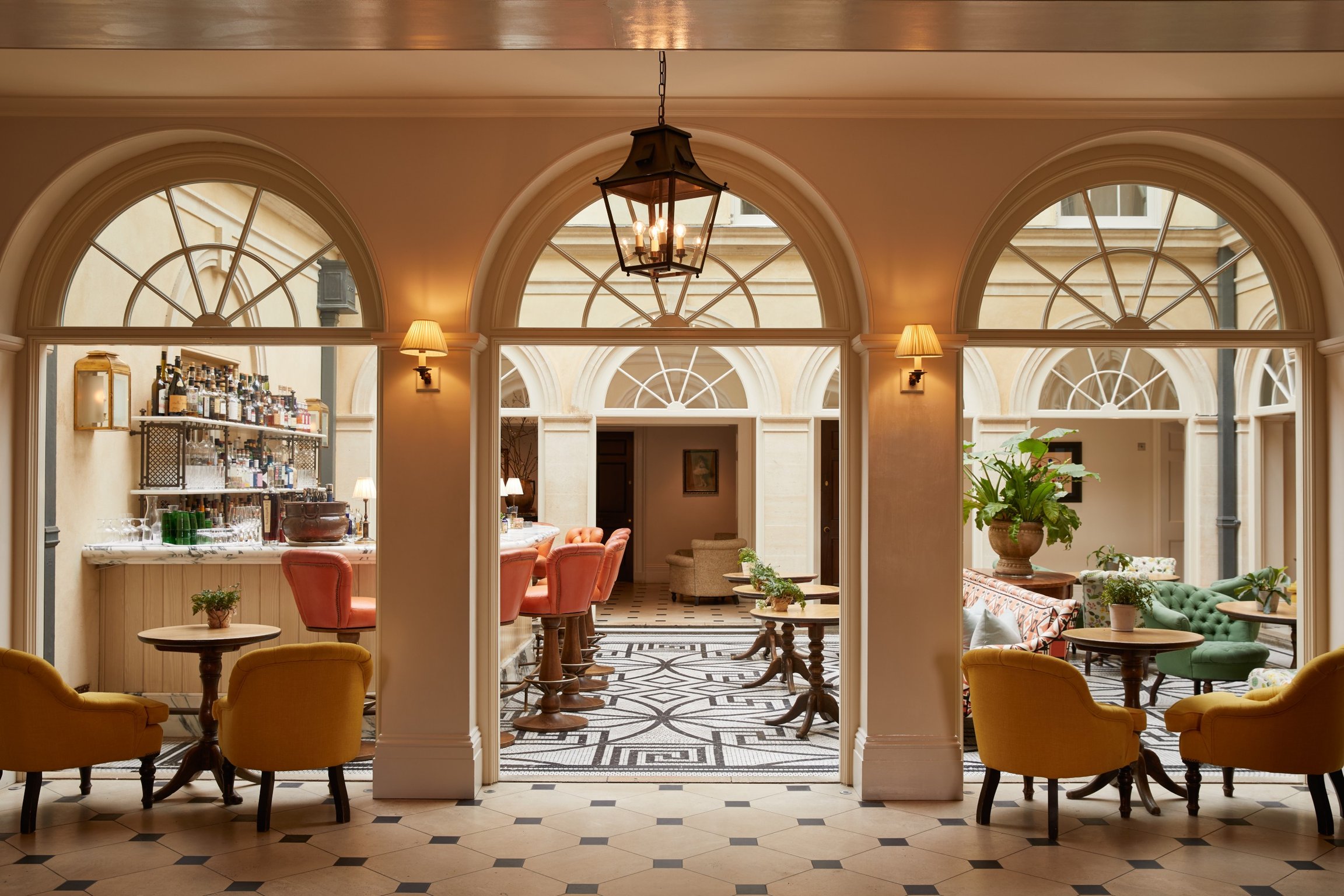 This Countryside Estate Is the English Manor of Our Dreams | Lime Wood Hotel bay window | Lime Wood Hotel exterior | Lime Wood Hotel suite with books and decor | Lime Wood Hotel cozy suite | Lime Wood Hotel sauna and pool | Lime Wood Hotel restaurant seating | Lime Wood Hotel bathtub in suite