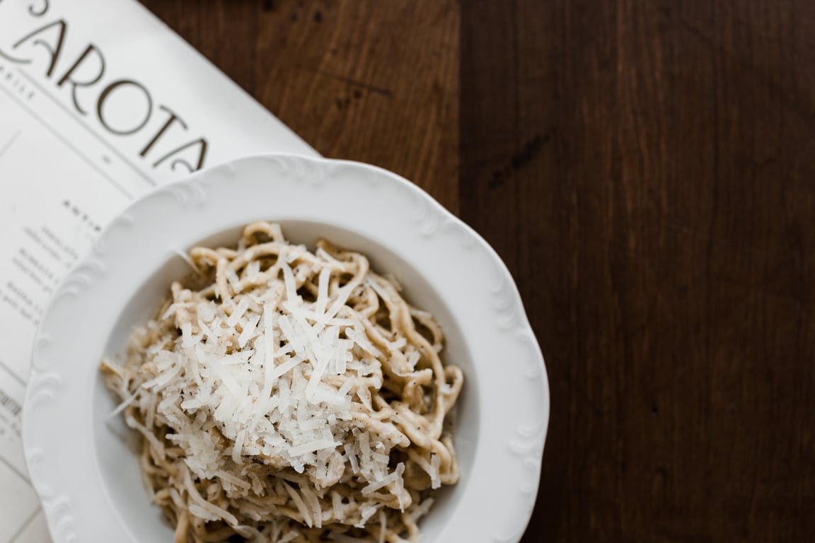 Here's Why This Award-Winning Italian Restaurant Is One of the Toughest Tables To Snag in NYC | Via Carota entrance | Via Carota founders Jody Williams and Rita Sodi | Via Carota Negroni and other drinks | Via Carota artichoke dish | Via Carota signature dish | Via Carota decor