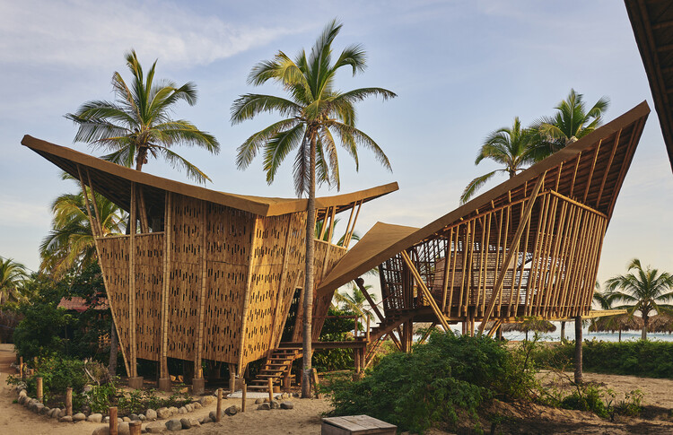 This Regenerative Eco-Resort in Mexico Uses Living Palm Trees in Every Room | Playa Viva Zihuatanejo hammocks | Playa Viva Zihuatanejo cabanas | Playa Viva Zihuatanejo outdoor yoga | Playa Viva Zihuatanejo dinner spread | Playa Viva Zihuatanejo suite