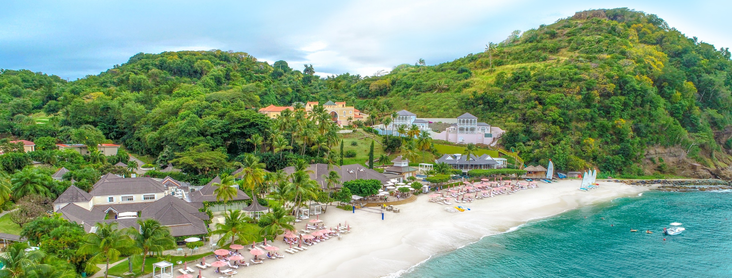 This All-Inclusive Wellness Resort Is Saint Lucia’s Best-Kept Secret | BodyHoliday hotel paddleboarding | BodyHoliday dinner spread | BodyHoliday bedroom | BodyHoliday exterior view