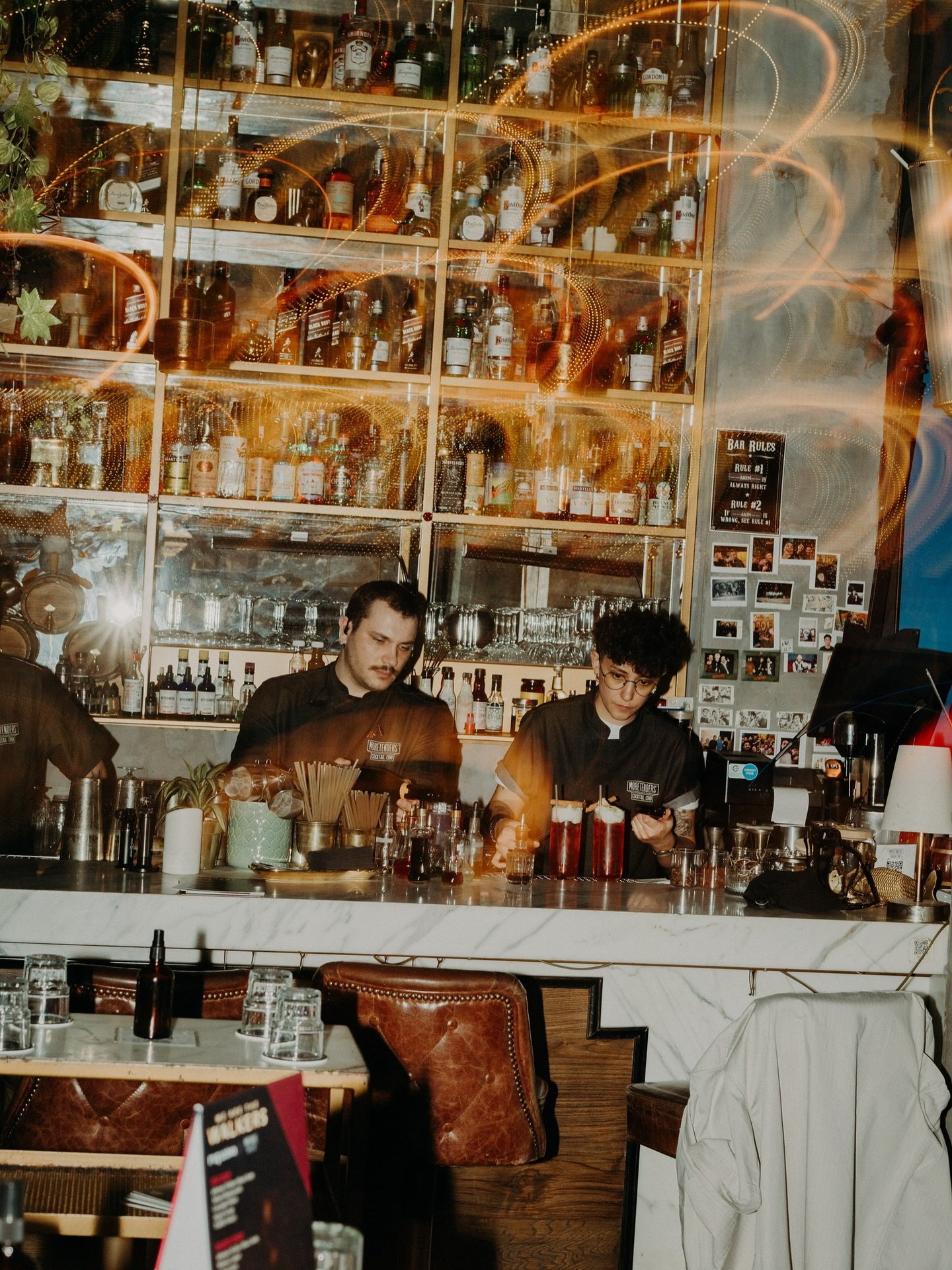 Bartenders behind the bar at Moretender's Cocktail Crib & Sushi