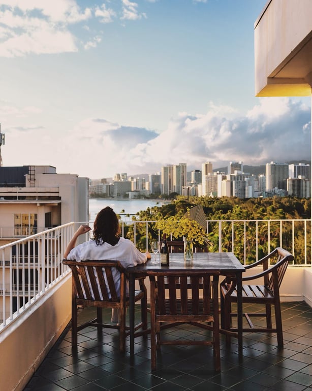 This Honolulu Hotel Is an Idyllic Escape from Waikiki’s Bustling Beaches | Lotus Honolulu balcony view | Lotus Honolulu aerial view | Lotus Honolulu suite decor | Lotus Honolulu bedroom suite | Lotus Honolulu suite seating | Lotus Honolulu couple biking | Lotus Honolulu restaurant dinner plate