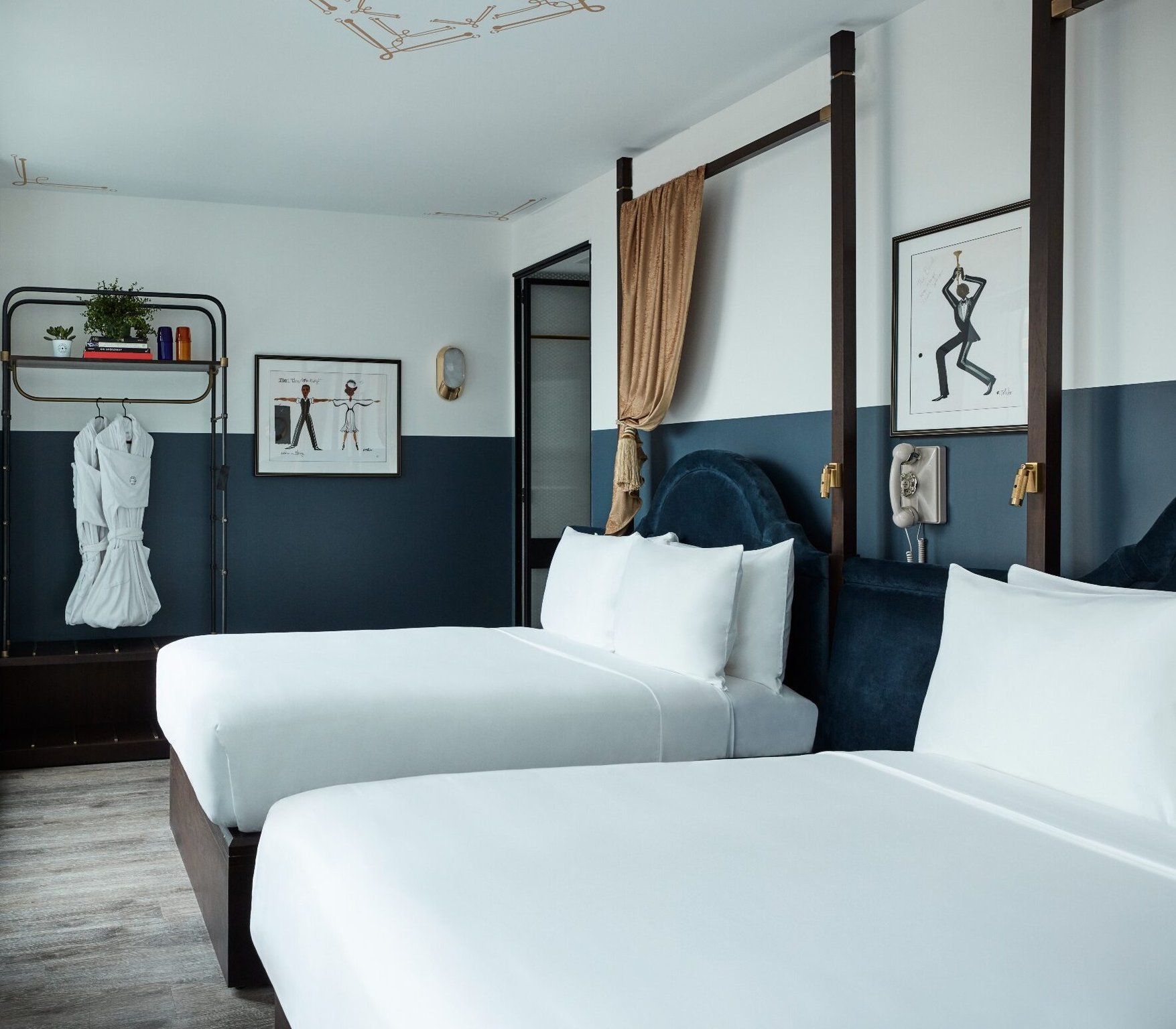 This Boutique Hotel Captures the Essence of Midtown NYC's Theater District in Its Design | Civilian Hotel entrance lobby | Civilian Hotel hallway | Civilian Hotel bedroom suite | Secret Garden at the Civilian Hotel by Nikolas Koenig | Civilian Hotel blue restaurant seating | Civilian Hotel restaurant | Civilian Hotel spiral staircase