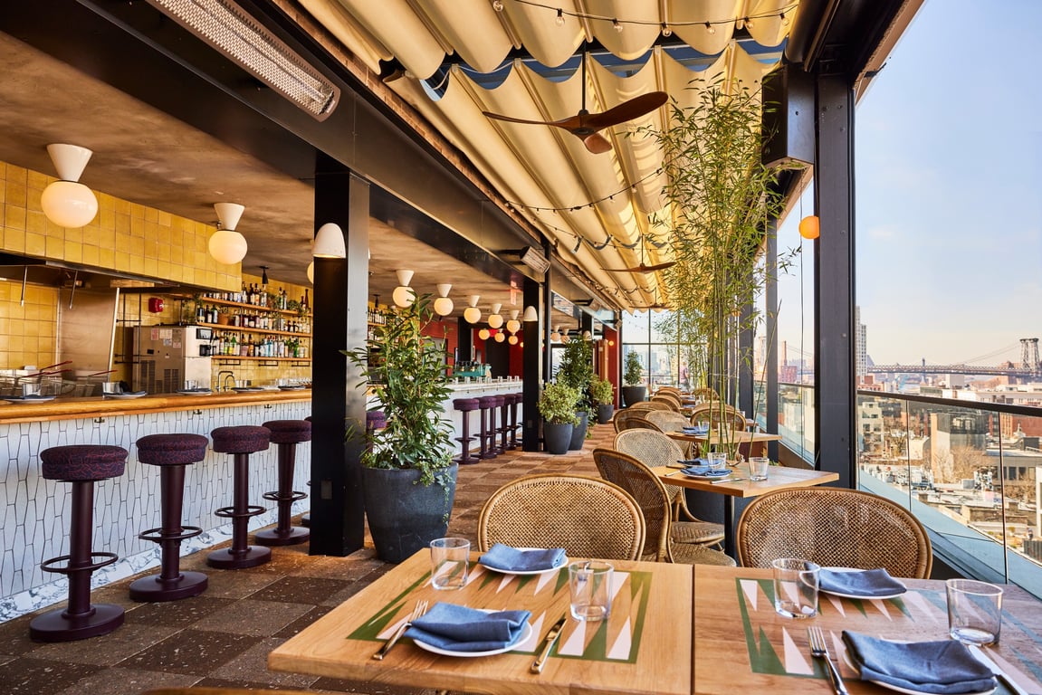 We Finally Understand Why It’s Nearly Impossible to Snag a Reservation at This Williamsburg Hotspot | Laser Wolf NYC rooftop seating | Laser Wolf NYC rooftop view | Laser Wolf NYC dinner spread | Laser Wolf NYC dips