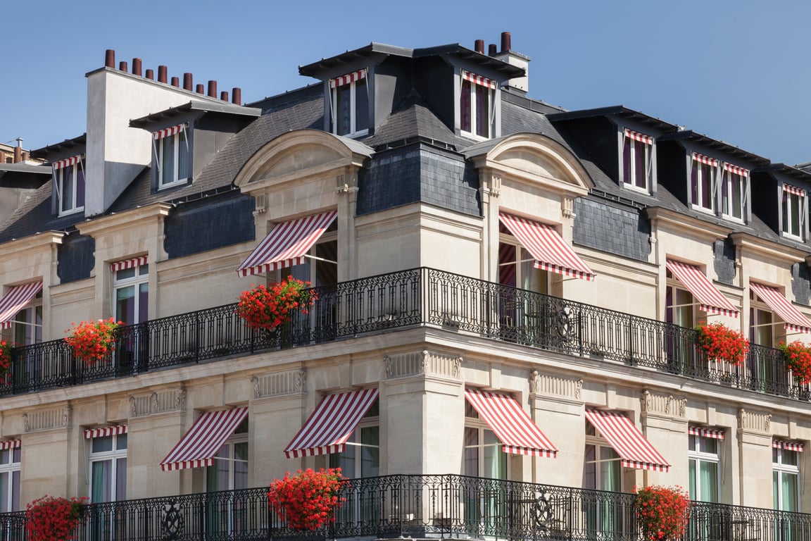 This Palatial Boutique Hotel in Paris Makes For a Luxurious Getaway | Le Bristol Paris lobby walkway | Le Bristol Paris entrance | Le Bristol Paris bedroom and bookcases | Le Bristol Paris bedroom | Le Bristol Paris garden dining | Le Bristol Paris Michelin starred dining | Le Bristol Paris sixth floor pool | Le Bristol Paris restaurant