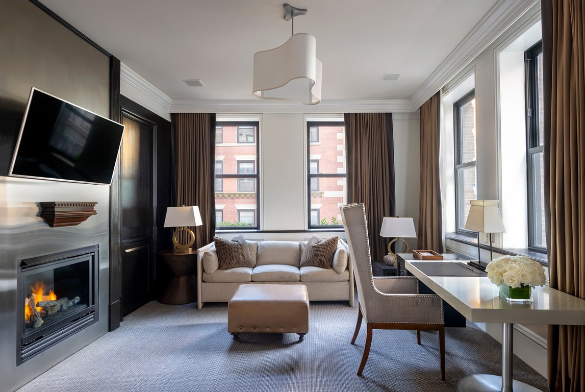 This Chic Boston Stay Is Pure Class | XV Beacon Boston chair in suite | XV Beacon Boston staircase | XV Beacon Boston outdoor restaurant | XV Beacon Boston restaurant dining | XV Beacon Boston suite living room | XV Beacon Boston bedroom suite | XV Beacon Boston entrance