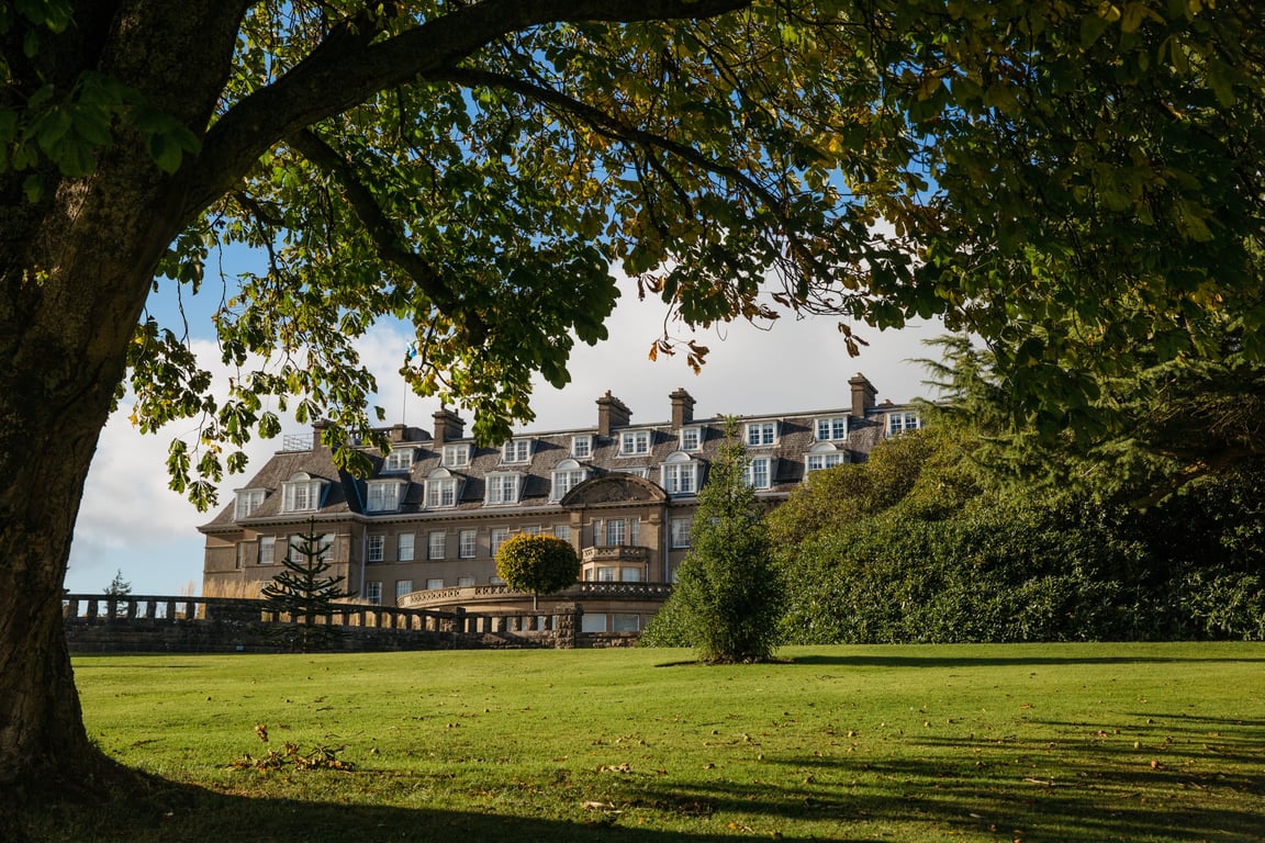 This 100-Year-Old Estate Is Arguably Scotland’s Best Hotel | Gleneagles hotel exterior | Gleneagles bedroom suite | Gleneagles hotel restaurant seating with a view | Gleneagles hotel restaurant | Gleneagles hotel bar