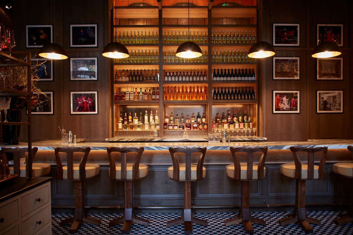 This Swanky Cocktail Haven in Midtown Manhattan Hosts the USA’s Largest Vermouth Collection | Rosevale Cocktail Room bar seating | Rosevale Cocktail Room wall picture art | Rosevale Cocktail Room bar cart | Rosevale Cocktail Room tasting flights