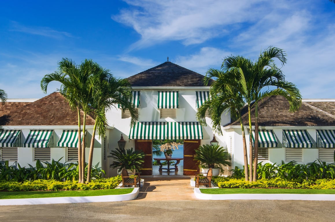 This 70-Year-Old Resort in Jamaica Is Steeped in History and Timeless Luxury | Round Hill Hotel and Villas courtyard | Round Hill Hotel and Villas exterior | Round Hill Hotel and Villas balcony | Round Hill Hotel and Villas outdoor cabana | Round Hill Hotel and Villas outdoor restaurant | Round Hill Hotel and Villas outdoor bar | This 70-Year-Old Resort in Jamaica Is Steeped in History and Timeless Luxury