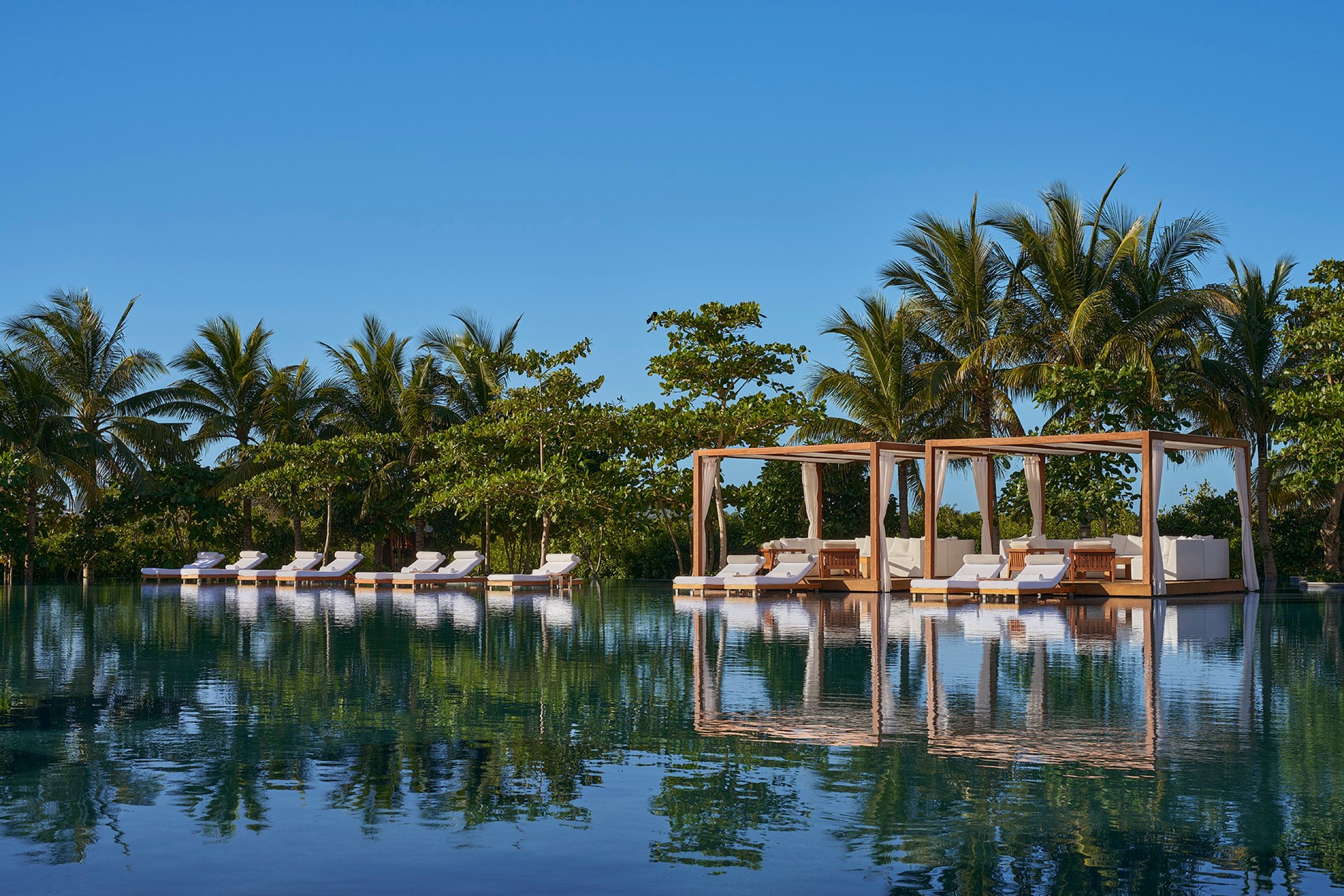 This New Hotel in Mexico Hosts North America’s Largest & Most Lavish Suite | The Riviera Maya Edition outdoor seating | The Riviera Maya Edition outdoor trail | The Riviera Maya Edition outdoor pool and cabanas | The Riviera Maya Edition bedroom | The Riviera Maya Edition lobby