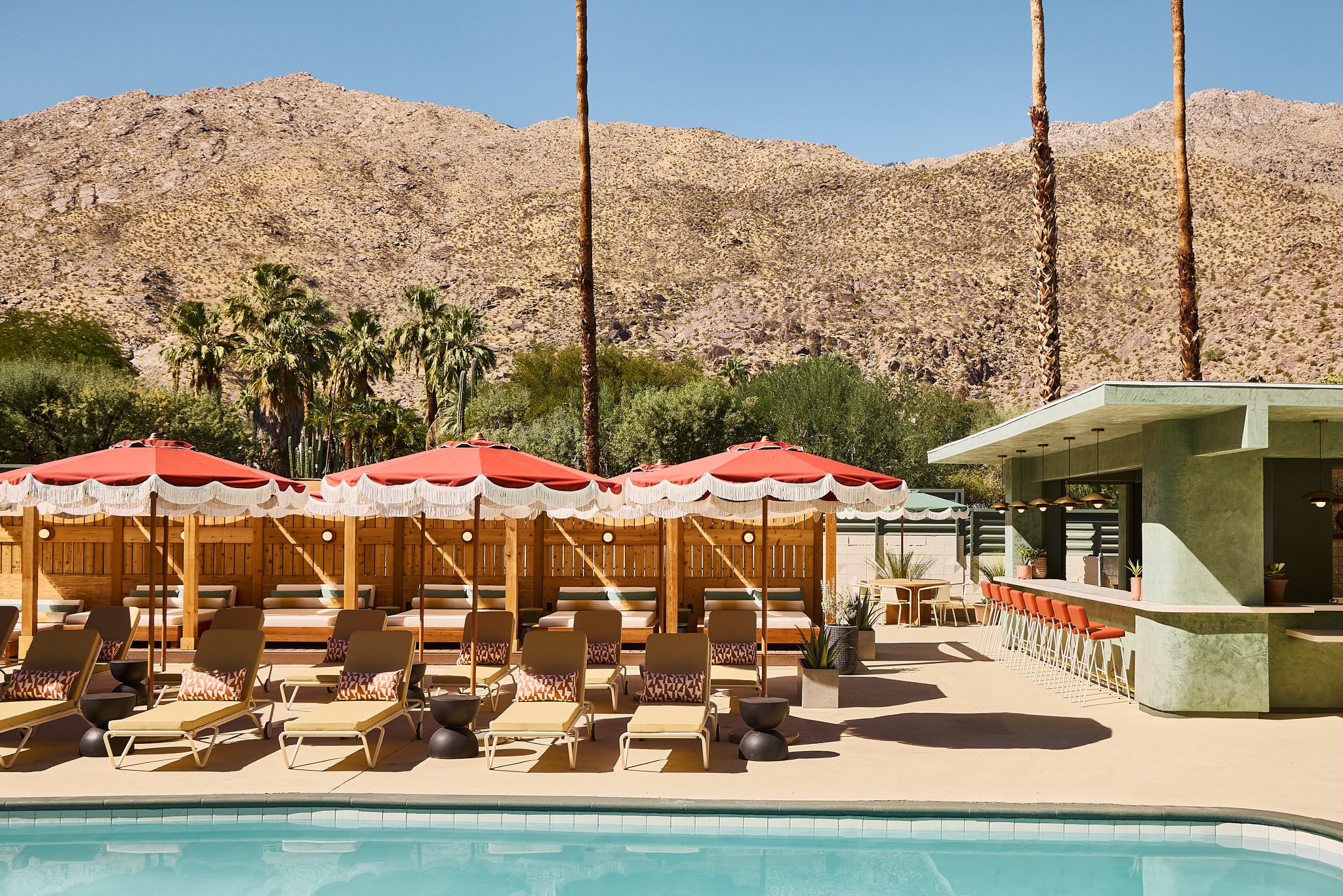 The Living Is Good at Palm Springs’ Newest Boutique Hotel | Life House Palm Springs poolside view | Life House Palm Springs exterior | Life House Palm Springs living room | Life House Palm Springs window view | Life House Palm Springs two beds in suite | Life House Palm Springs man at the pool