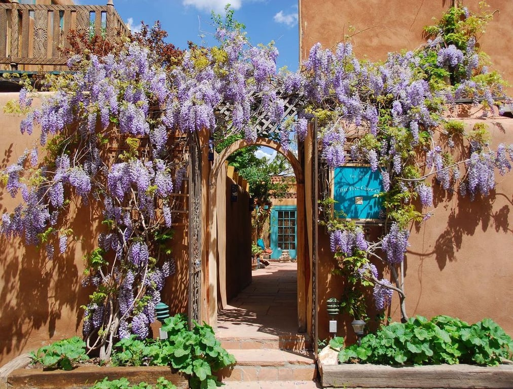 This Santa Fe, New Mexico, Hotel & Spa Is a Journey through the Senses | The Inn of Five Graces spa beds | The Inn of Five Graces room suite | The Inn of Five Graces bath spa | The Inn of Five Graces hallway | The Inn of Five Graces living room | The Inn of Five Graces courtyard | The Inn of Five Graces restaurant