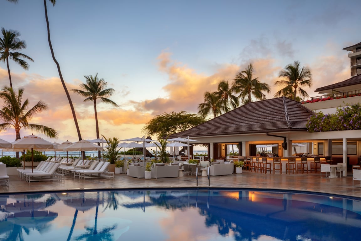 This Century-Old Boutique Hotel in Waikiki Evokes Timeless Elegance | Halekulani Hotel exterior | Halekulani Hotel greenery | Halekulani Hotel outdoor pool | Halekulani Hotel surfboards | Halekulani Hotel bedroom | Halekulani Hotel restaurant | Halekulani Hotel courtyard at night